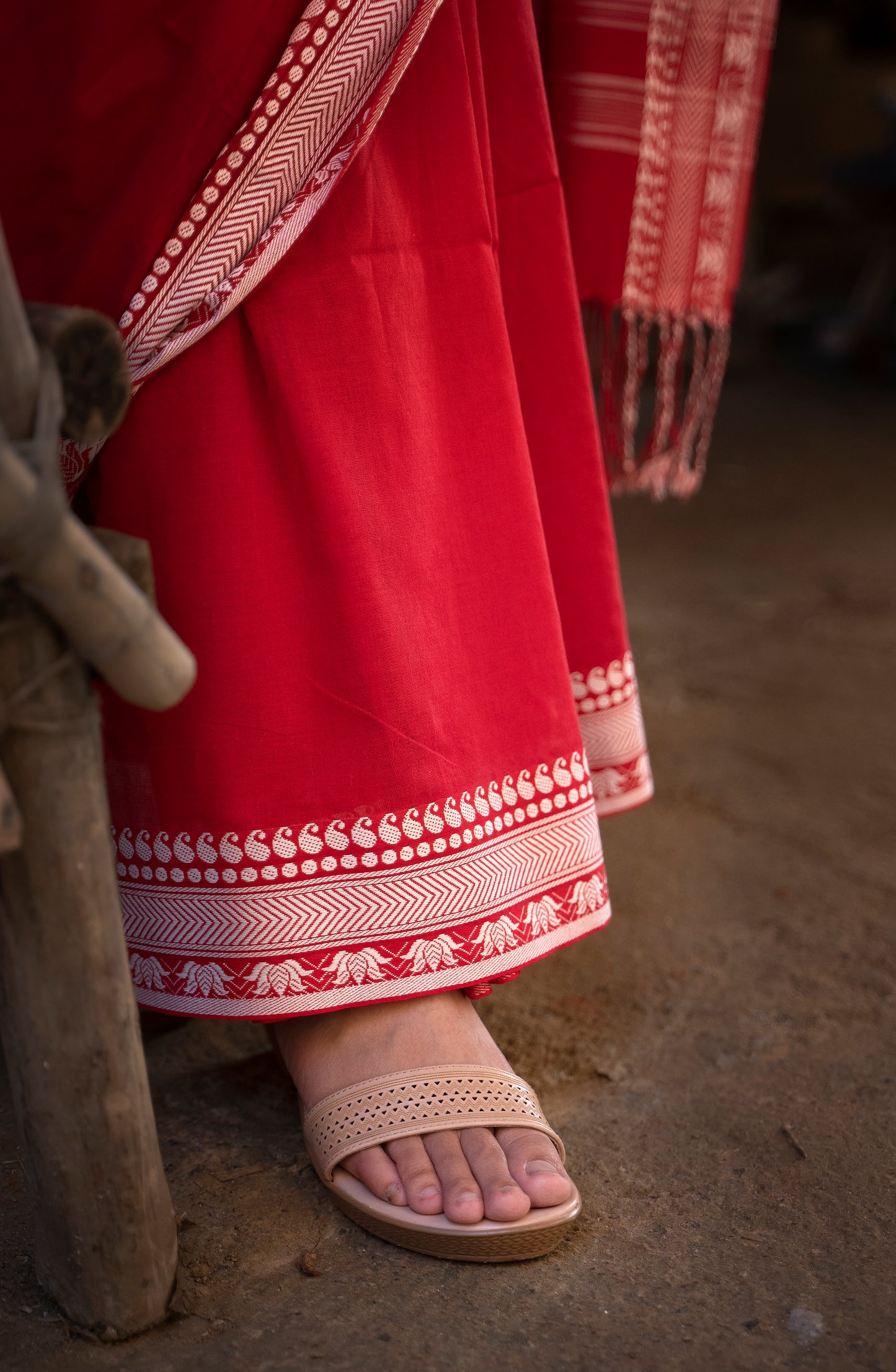 Devii Saree – Red handcrafted saree with lotus & paisley border, honoring everyday women