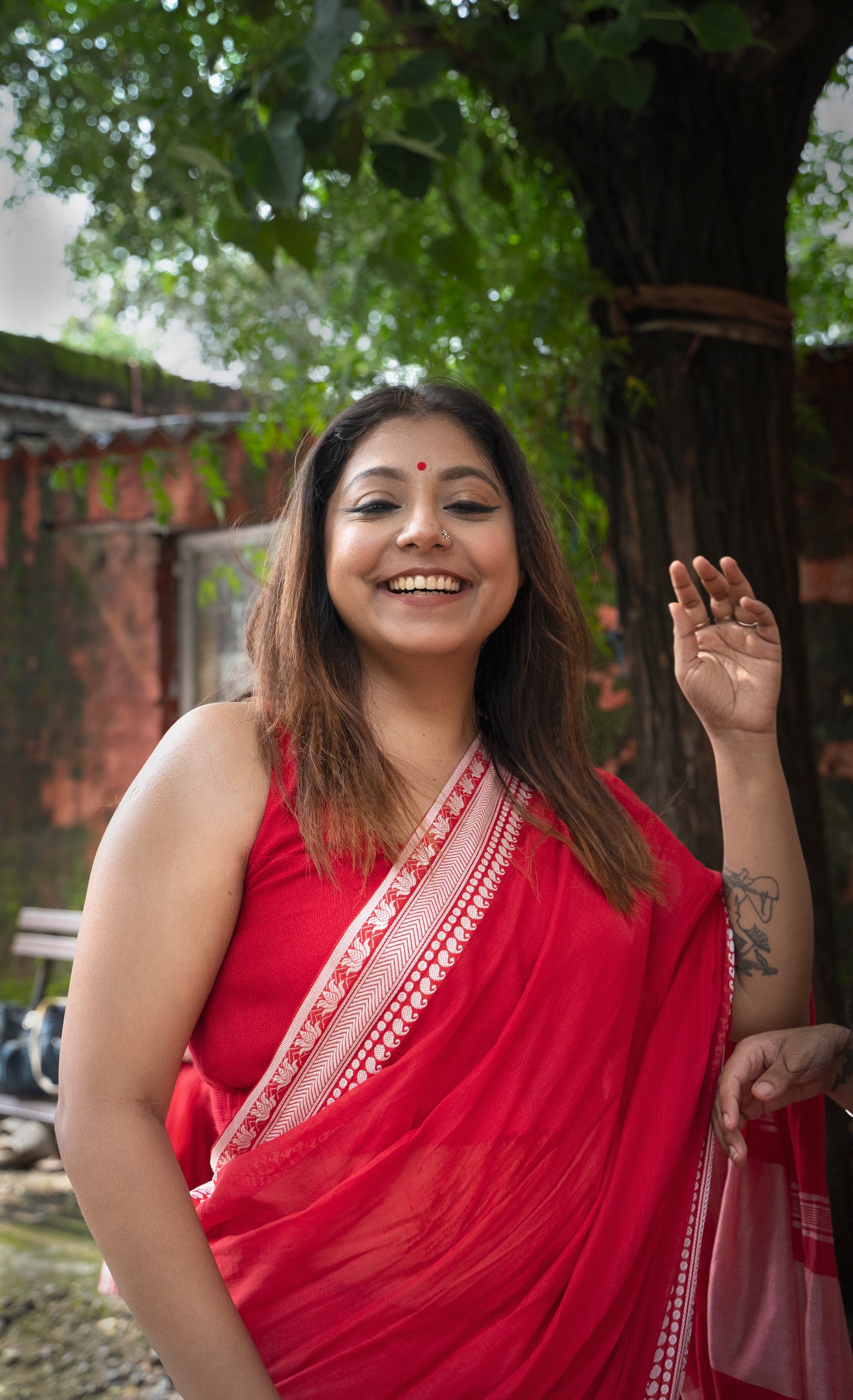 Devii Saree – Red handcrafted saree with lotus & paisley border, honoring everyday women